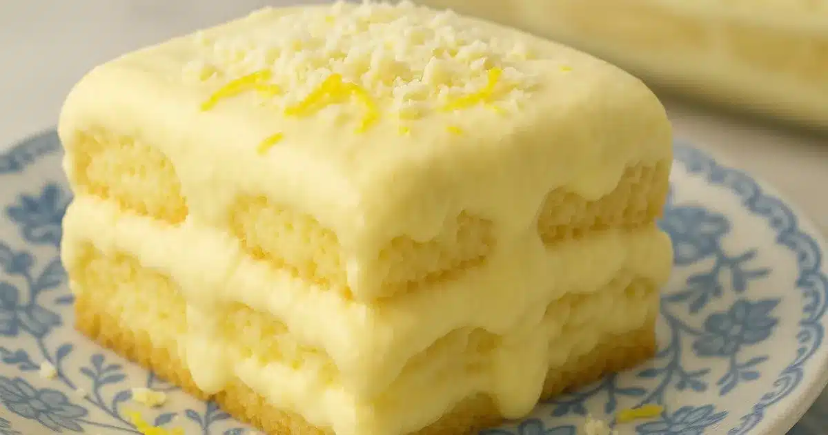 Creamy limoncello tiramisu slice with mascarpone layers on blue floral dessert plate